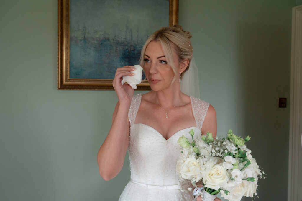 The Bride wiping away a tear as she has a first look with her boys at the Parley Manor House
