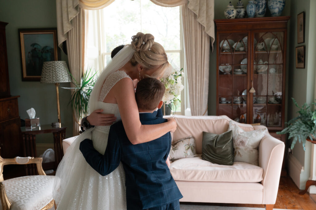 The bride giving her two sons a big hug after having a first look before their ceremony