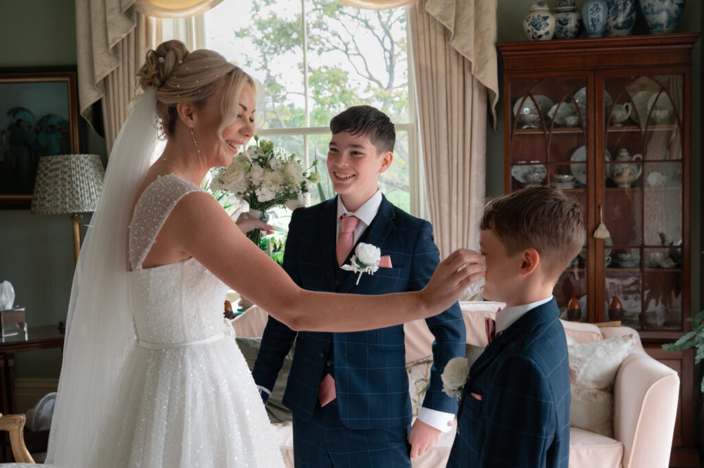 Bride wiping her son's tears away
